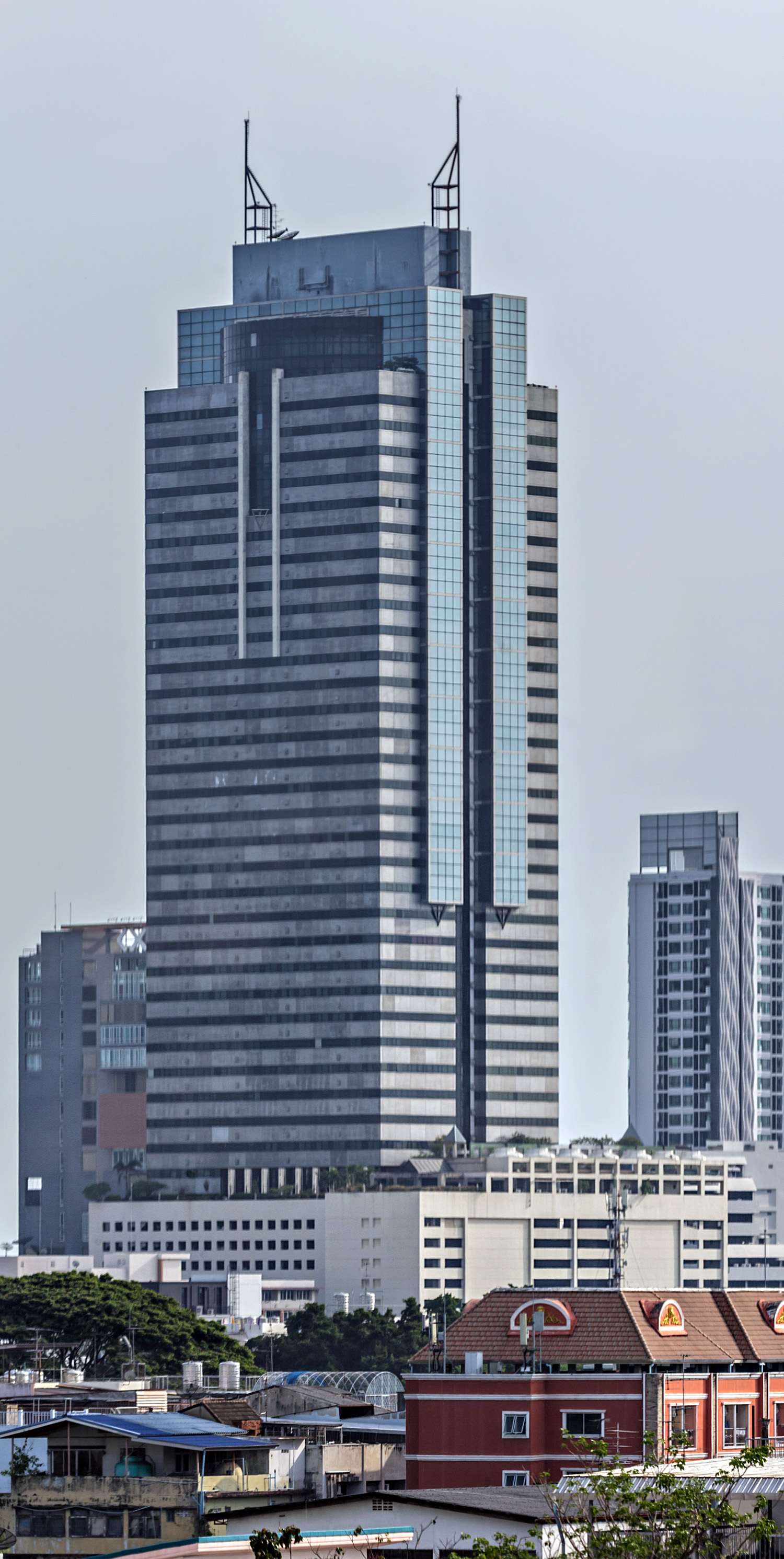 Sinn Sathorn Tower - Blurry photo through a monorail window 